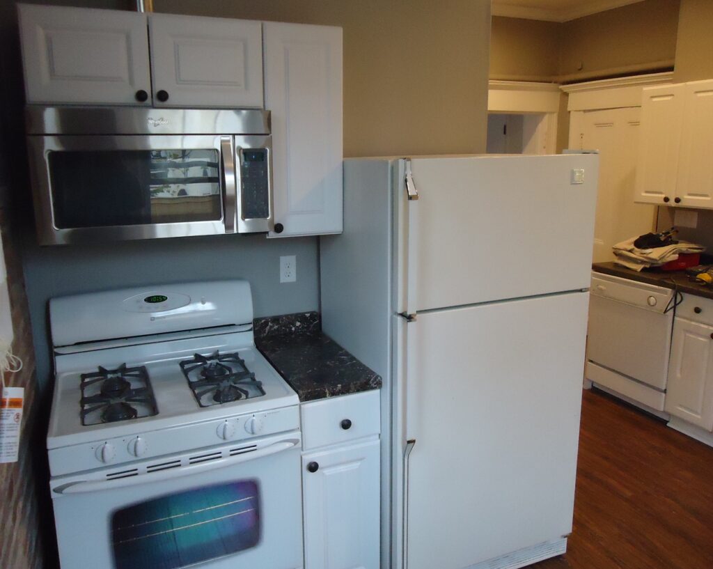 Kitchen renovation project cabinets finished microwave installed new floor painted walls and ceiling